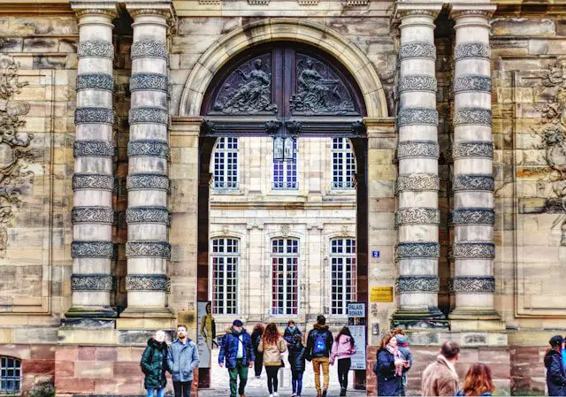 people standing in front of brown concrete building during daytime