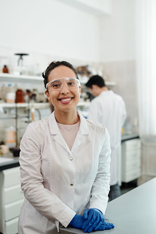 portrait of female scientist in white lab coat smiling