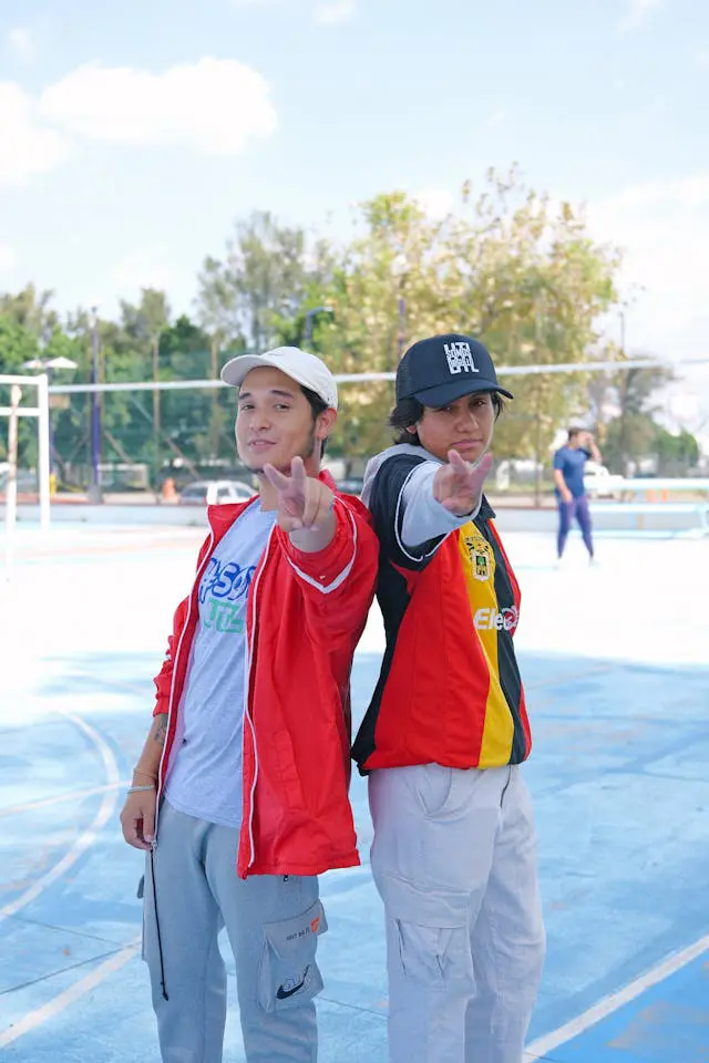youthful duo posing in vibrant attire outdoors