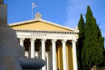 a building with columns and a flag on top