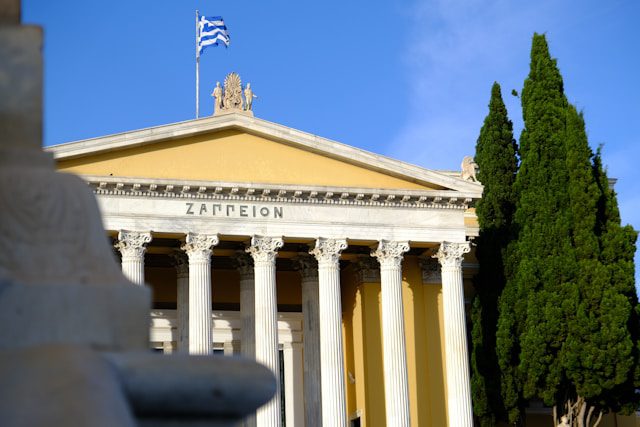 a building with columns and a flag on top