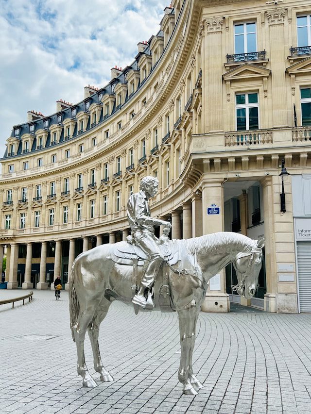 a statue of a man on a horse in front of a building