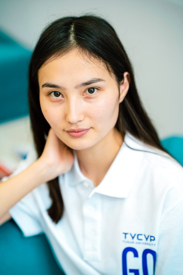 a woman with her hand on her chin