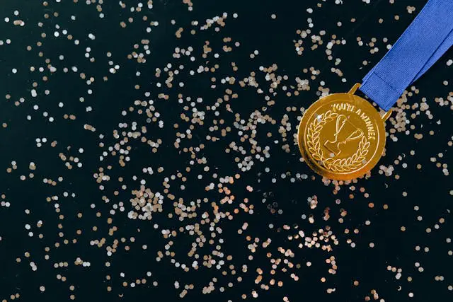 close up shot of a gold medal on a black surface