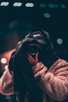 faceless photographer in warm clothes taking photo