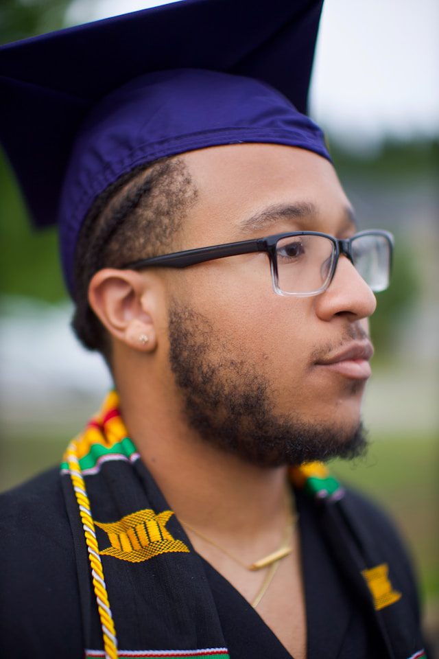 a man wearing a graduation cap and gown