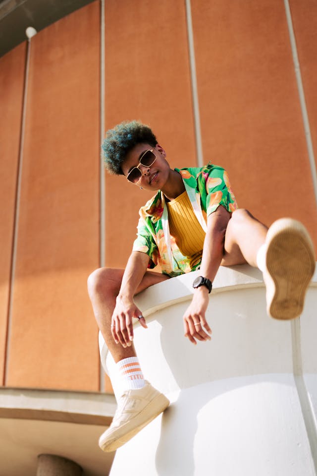 a young man sitting on top of a white object