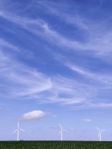 white wind turbines under blue sky and white clouds