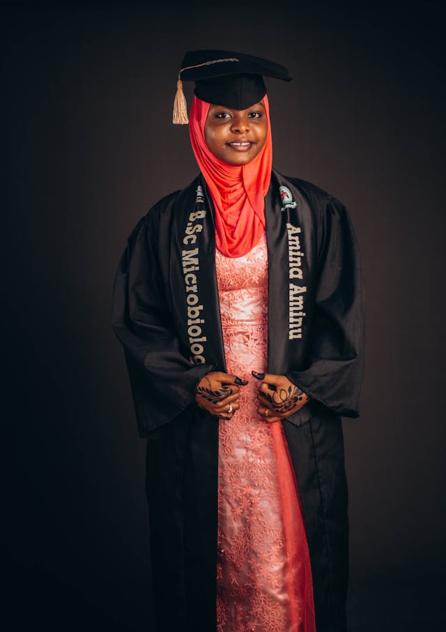 young woman in graduation attire with hijab