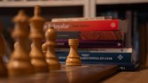 chess pieces and books in cozy library