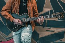 a person playing the electric guitar