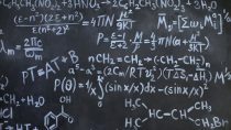 close up of complicated equations written on a blackboard