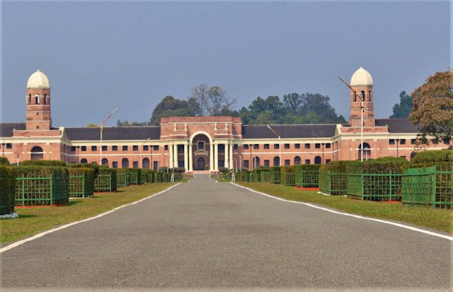 a large brick building with two towers on top of it